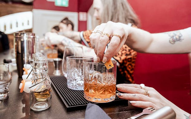 Hands preparing cocktails at the Irish Whiskey Museum masterclass.