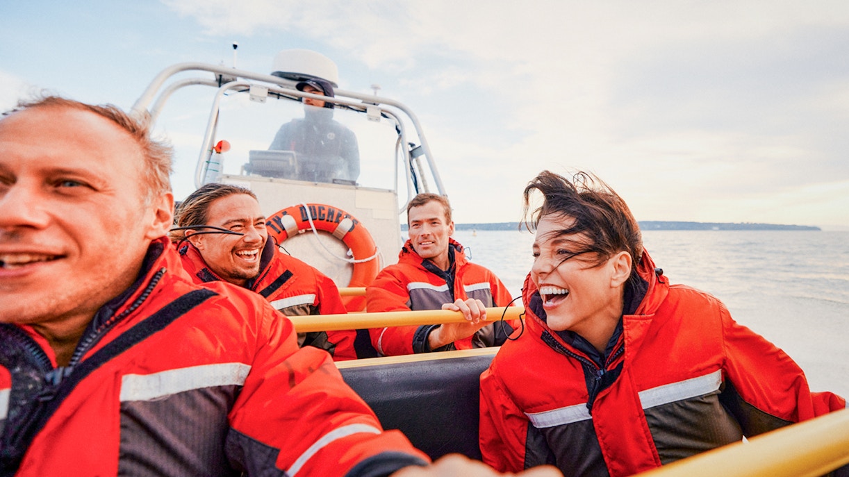 Whale watching tour group on a boat in Victoria, Canada, observing the ocean.