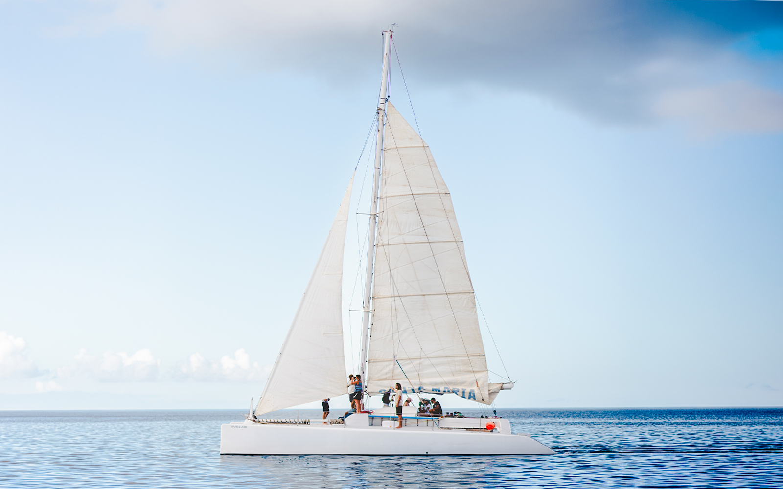 Tourists on a sailboat in Lanzarote waters for whale and dolphin watching.