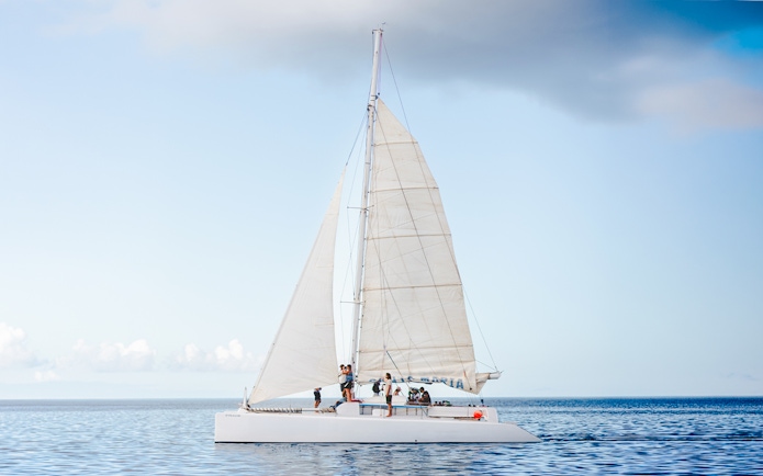 Tourists on a sailboat in Lanzarote waters for whale and dolphin watching.