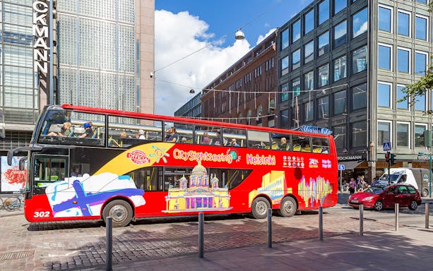Hop-On Hop-Off tour bus in Helsinki city center near Stockmann building.