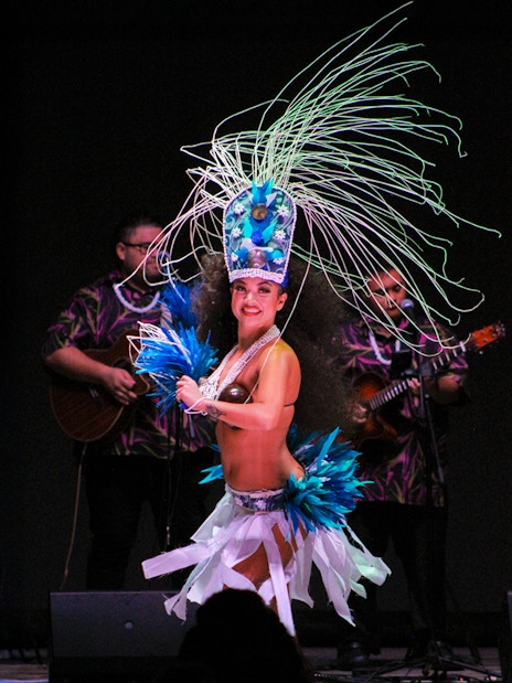 Performer in traditional attire dancing at Moana Luau, Hawaii.