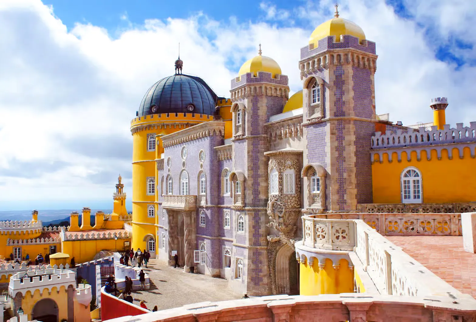 Pena Palace in Sintra with colorful towers and intricate architecture.
