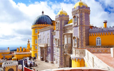 Pena Palace in Sintra with colorful towers and intricate architecture.