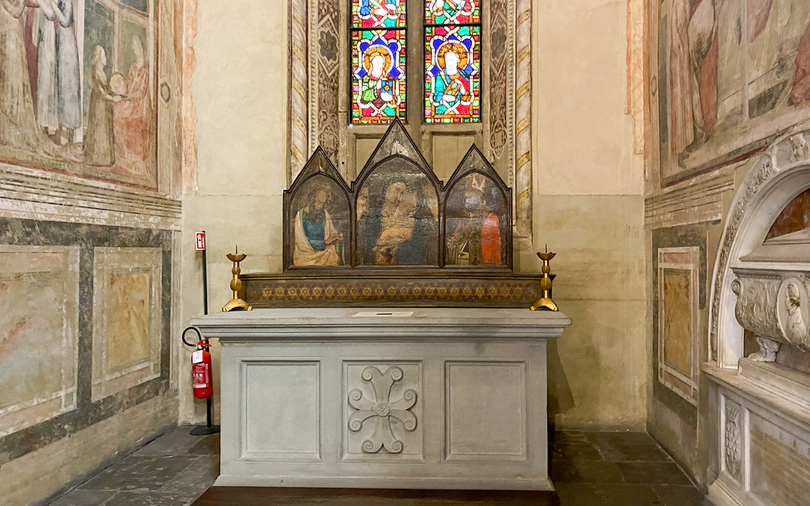 Santa Croce chapel altar with frescoes and stained glass in Florence.