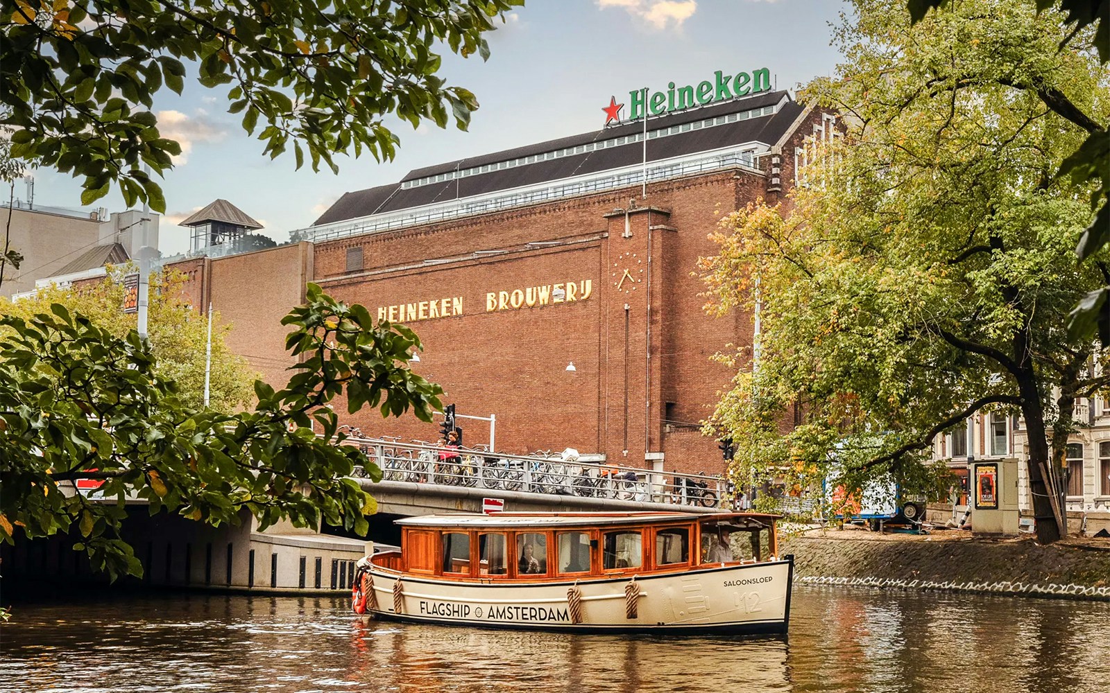 Heineken Brewery with canal cruise boat in Amsterdam.