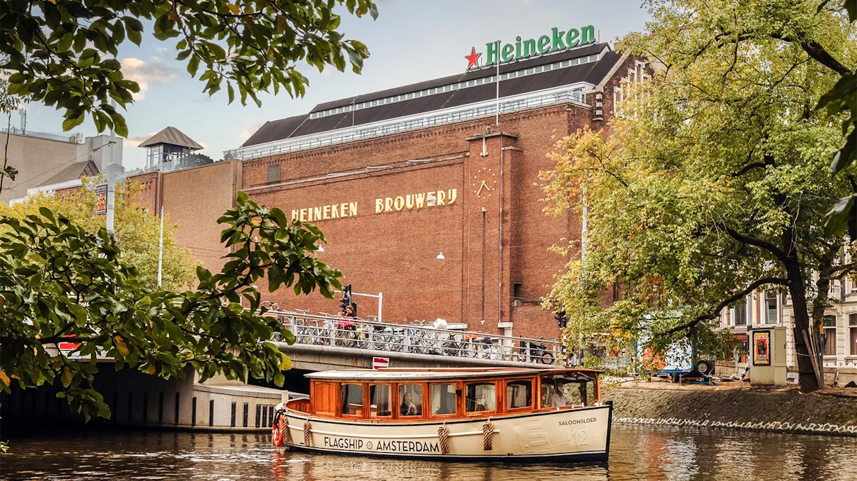 Heineken Brewery with canal cruise boat in Amsterdam.