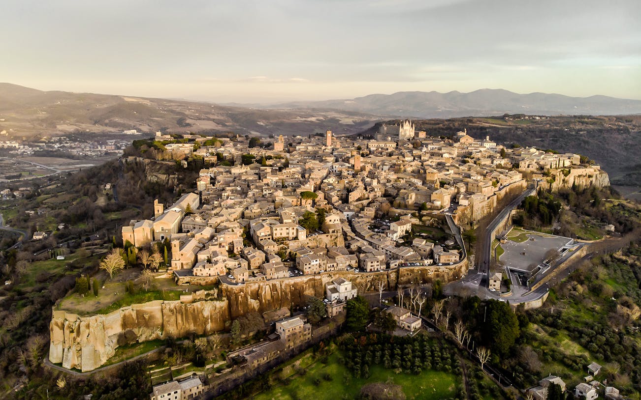 Aerial view of Orvieto, Italy, showcasing historic buildings and surrounding landscape.
