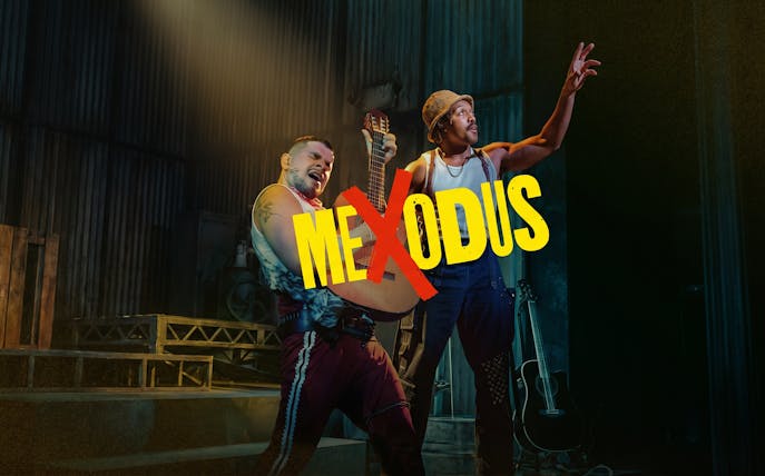 Performers on stage during Mexodus the Musical in New York, one holding a guitar.