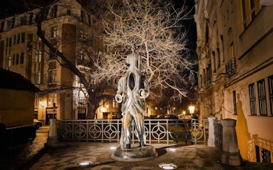 Statue of Franz Kafka at night in Old Town Prague during Ghosts & Legends tour.