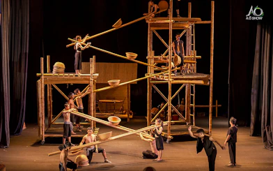 Performers using bamboo scaffolding in a traditional AO show.