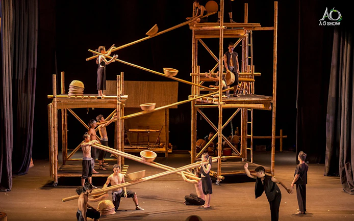 Performers using bamboo scaffolding in a traditional AO show.