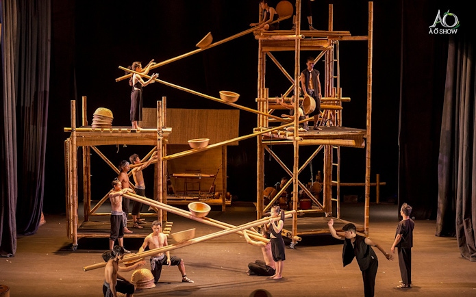 Performers using bamboo scaffolding in a traditional AO show.