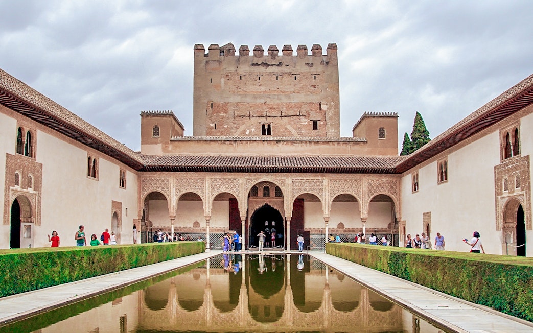 Alhambra's Nasrid Palaces courtyard with reflecting pool, Granada, Spain.