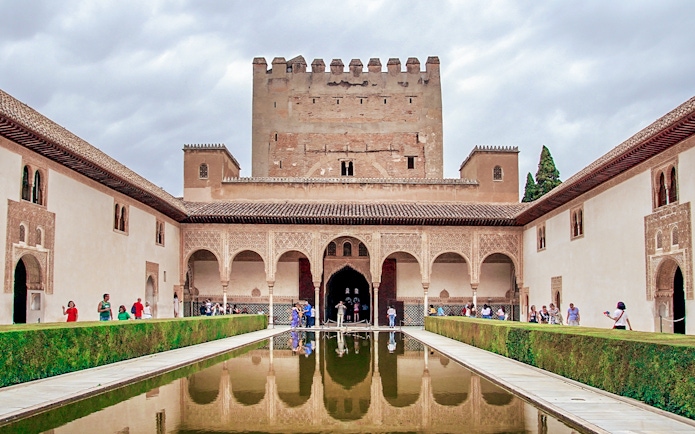 Alhambra's Nasrid Palaces courtyard with reflecting pool, Granada, Spain.