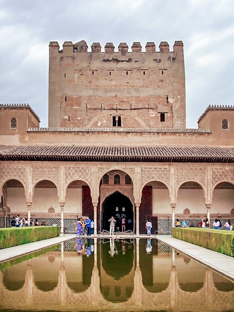 Alhambra's Nasrid Palaces courtyard with reflecting pool, Granada, Spain.