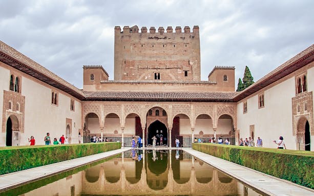 Alhambra's Nasrid Palaces courtyard with reflecting pool, Granada, Spain.