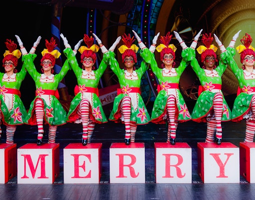 Rockettes performing in festive costumes at Radio City Christmas Spectacular.