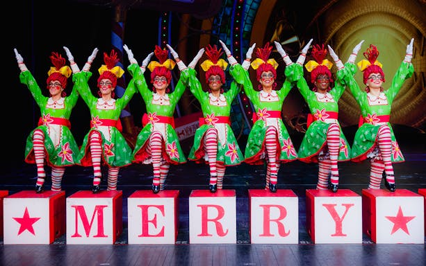 Rockettes performing in festive costumes at Radio City Christmas Spectacular.
