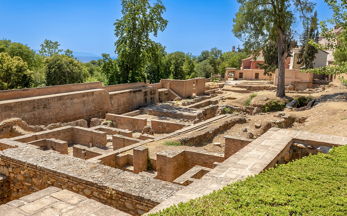 Ancient ruins surrounded by greenery on the Alhambra Surroundings Tour.