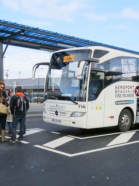 Passengers boarding bus at Paris Beauvais airport bus stop.