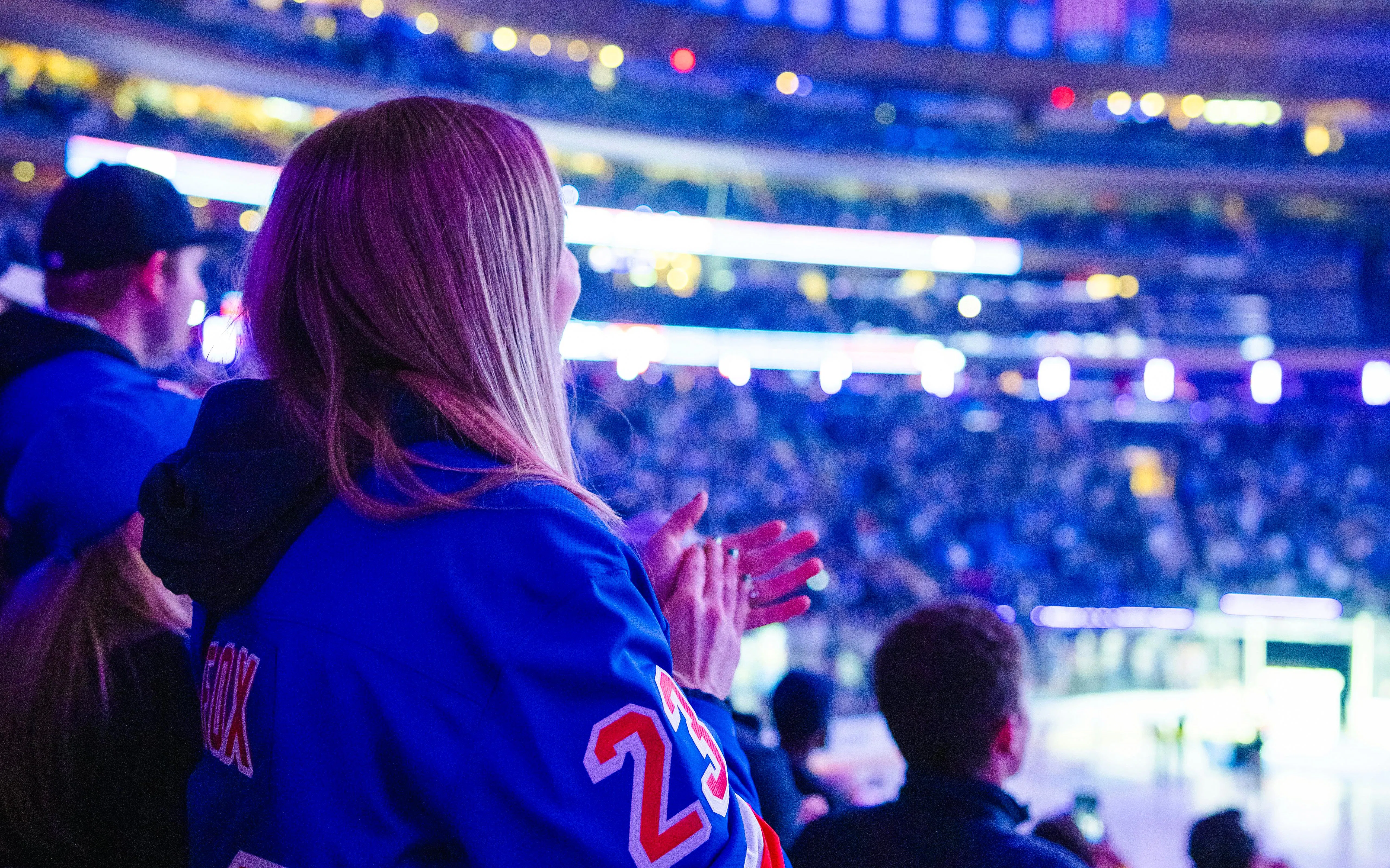 Fans cheering at a New York Rangers game in Madison Square Garden.