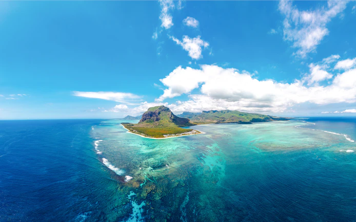 Aerial view of Le Morne Brabant peninsula surrounded by turquoise waters in Mauritius.