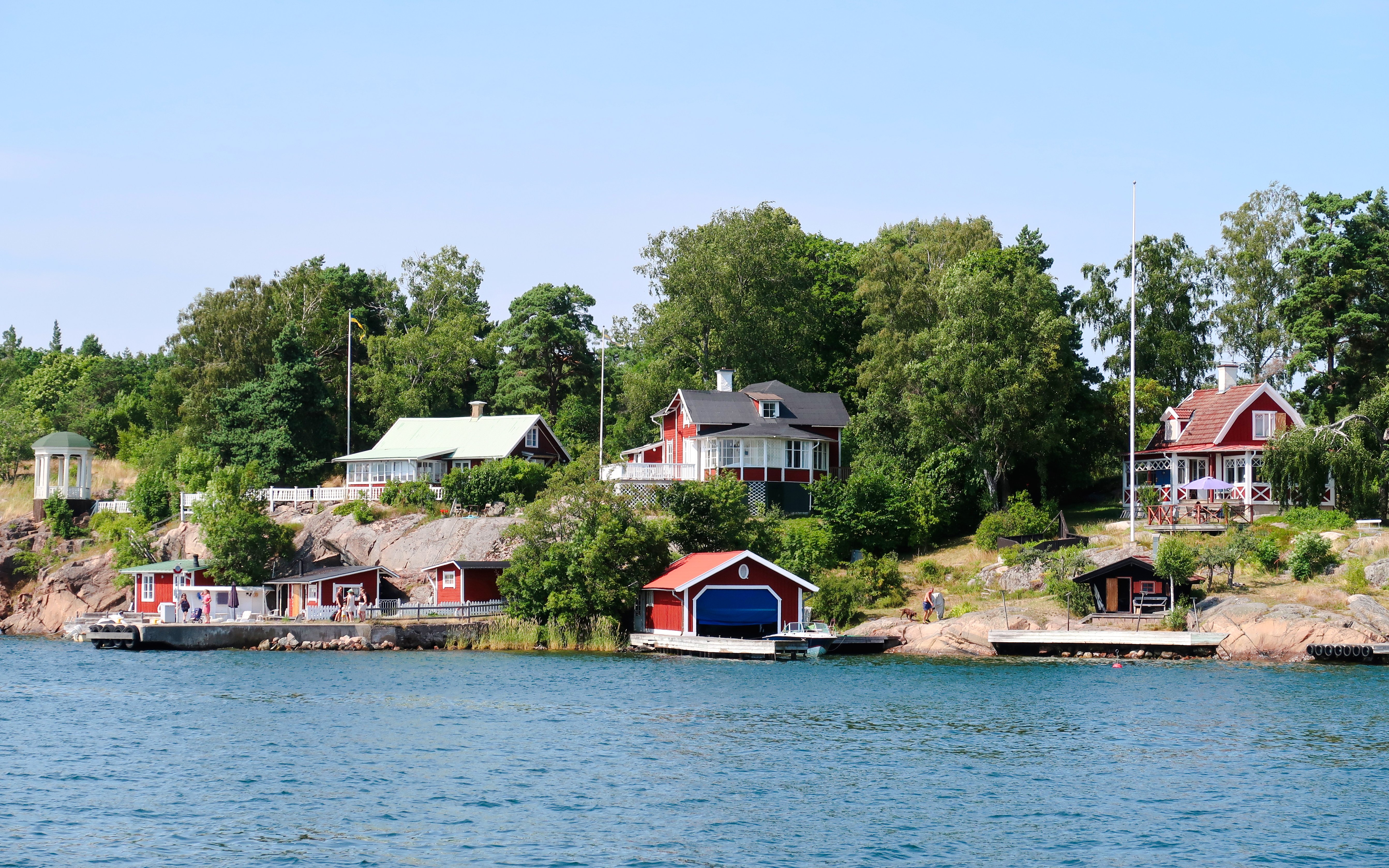 Colorful houses along the shoreline of the Stockholm archipelago in Sweden.