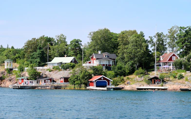 Colorful houses along the shoreline of the Stockholm archipelago in Sweden.