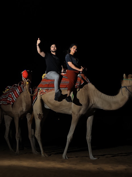 Camel ride at night during Arabian Dunes Premium Safari with Bedouin Camp Experience.