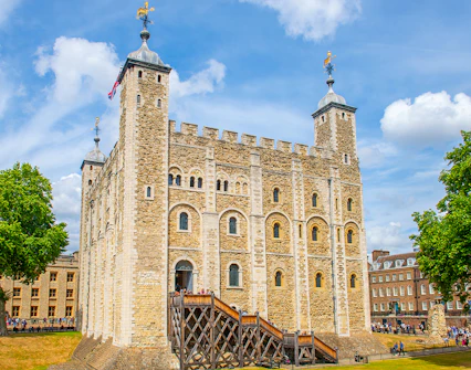 Tower of London with tourists exploring the grounds, London.