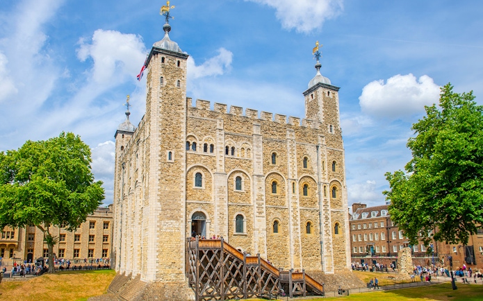 Tower of London with tourists exploring the grounds, London.
