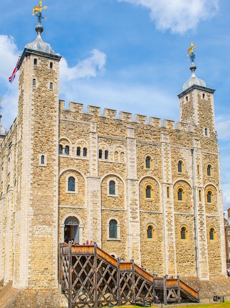 Tower of London with tourists exploring the grounds, London.