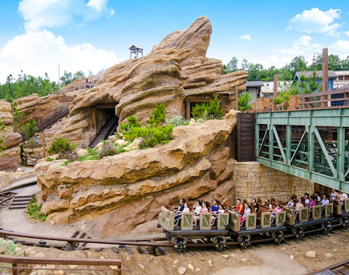 Big Grizzly Mountain Runaway Mine Cars ride at Hong Kong Disneyland with rocky landscape.