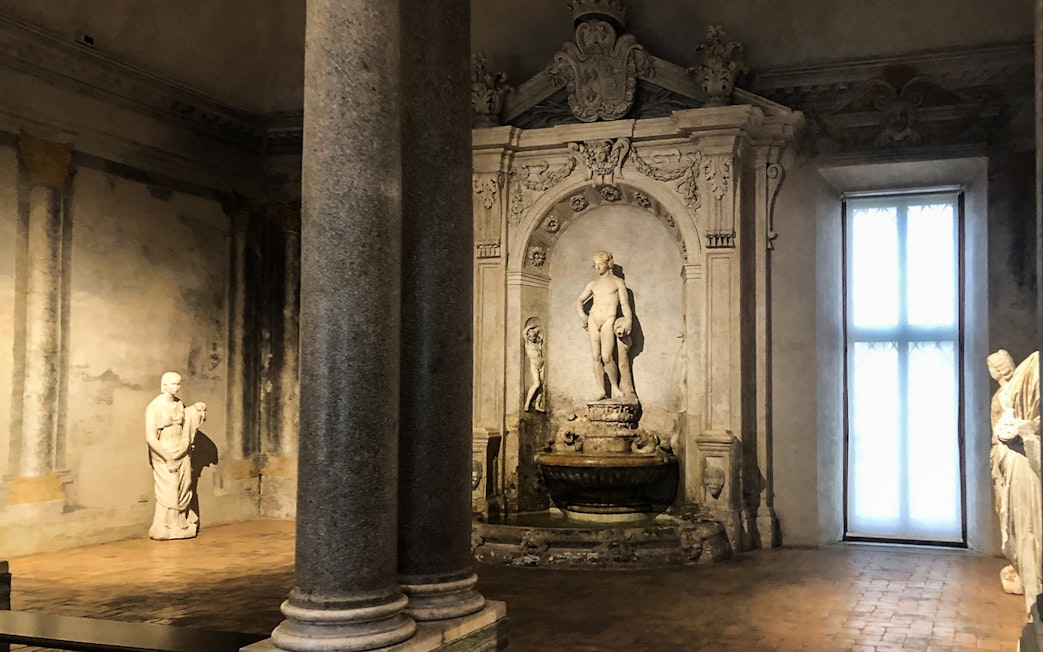 Statues and ornate fountain inside Palazzo Barberini, Rome.