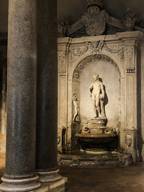 Statues and ornate fountain inside Palazzo Barberini, Rome.