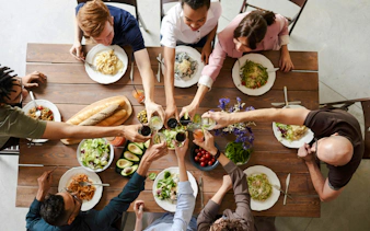 Group enjoying a meal with traditional dishes on a Bucharest food tour.