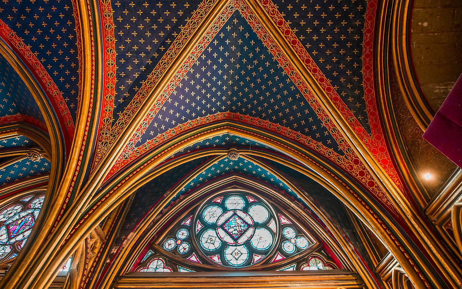 Vaulted ceiling in dark blue with golden motifs at Lower Chapels in Sainte Chapelle