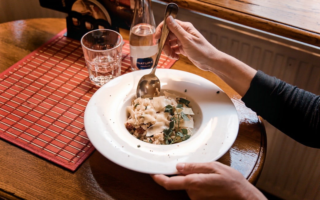 Dining experience in Prague with a plate of pasta, part of the Old Town tour.