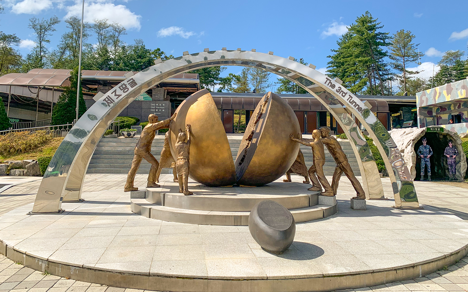 Sculpture of figures pushing a divided sphere at DMZ 3rd Tunnel, South Korea.