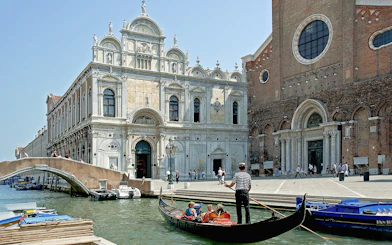 Gondola ride near Scuola Grande di San Marco, Venice, on a full-day guided tour.
