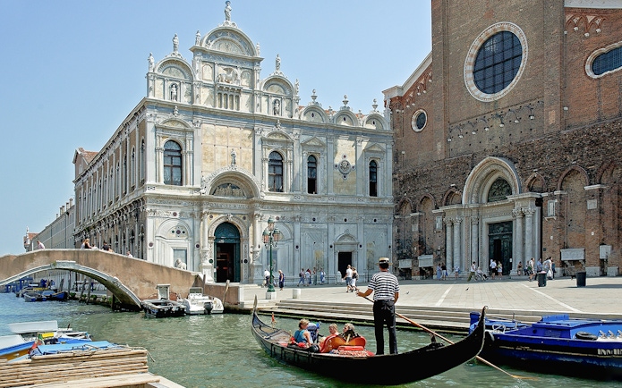 Gondola ride near Scuola Grande di San Marco, Venice, on a full-day guided tour.