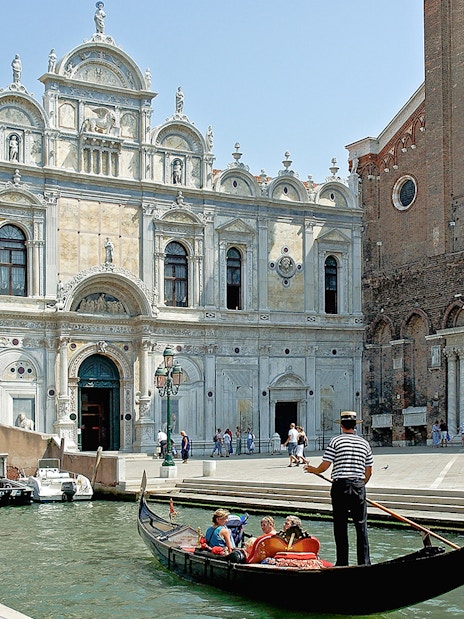 Gondola ride near Scuola Grande di San Marco, Venice, on a full-day guided tour.