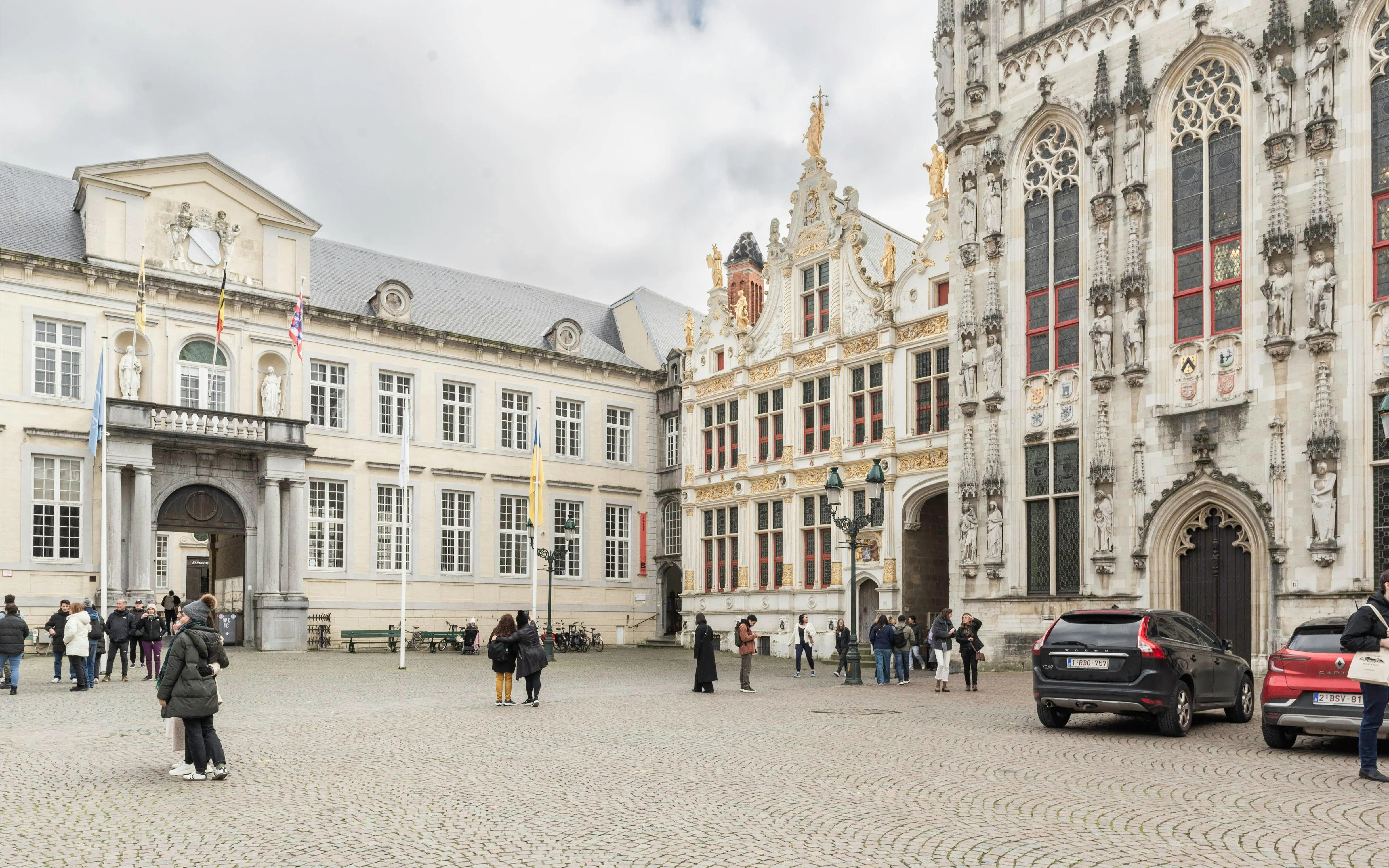 Brugse Vrije historic building facade with visitors in Bruges, Belgium.