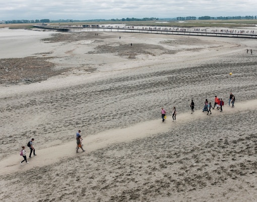 View of people walking around the Mont Saint-Michel bay