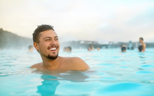 Man enjoying the Blue Lagoon geothermal spa in Iceland.
