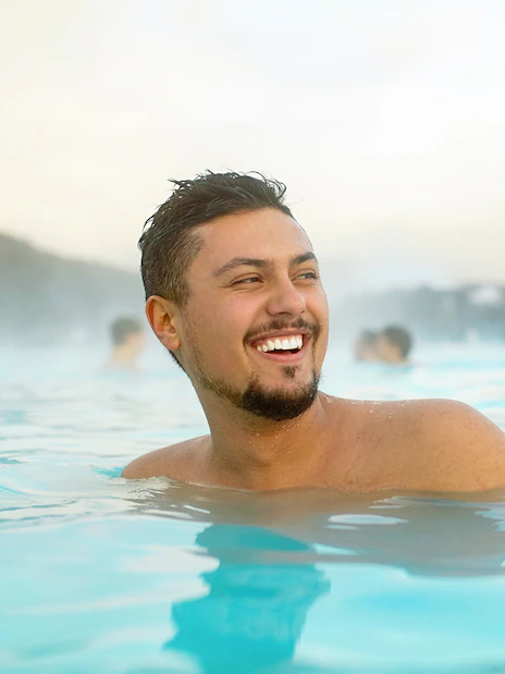 Man enjoying the Blue Lagoon geothermal spa in Iceland.