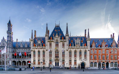 Exterior view of Historium Bruges with Gothic architecture and spires in Bruges, Belgium.
