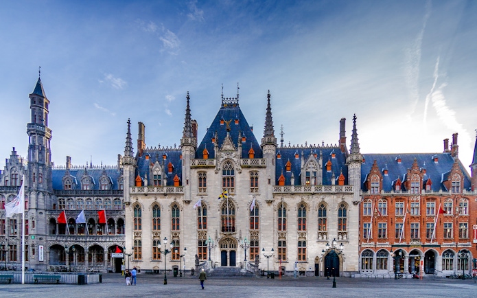 Exterior view of Historium Bruges with Gothic architecture and spires in Bruges, Belgium.