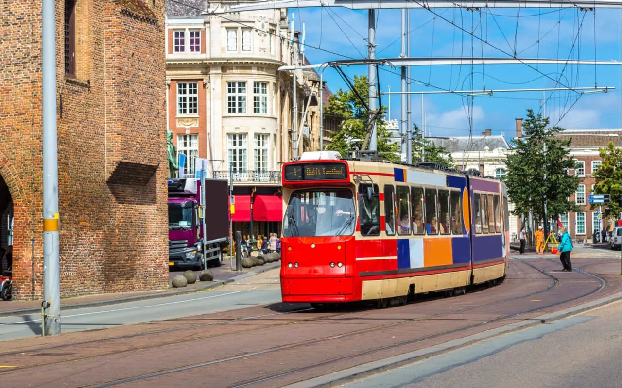 Tram passing through the historic center of The Hague during a city exploration game.